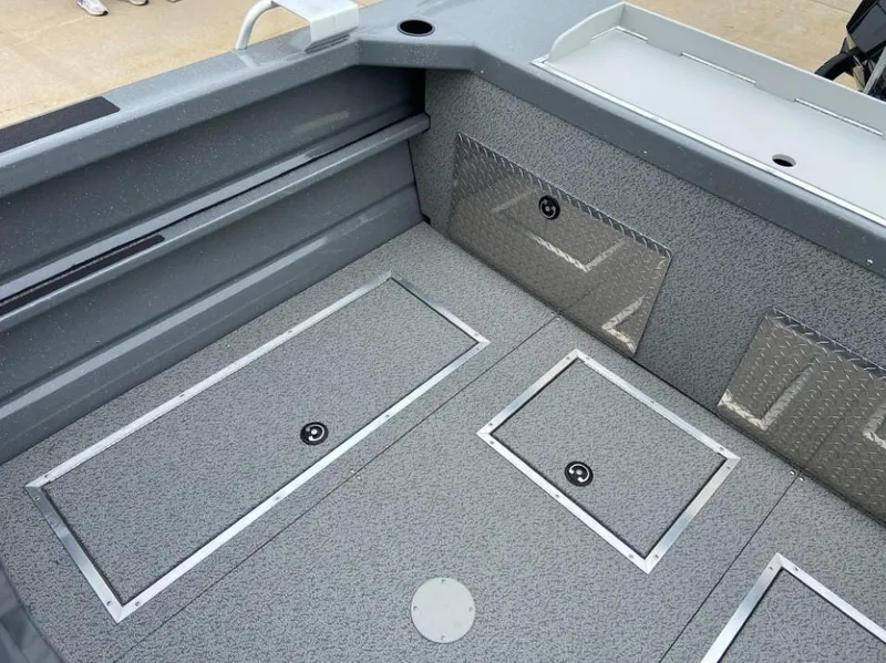 Slide: The Image of 2024 Spartan 200 Astoria boat interior with storage compartments and non-slip flooring. - 11