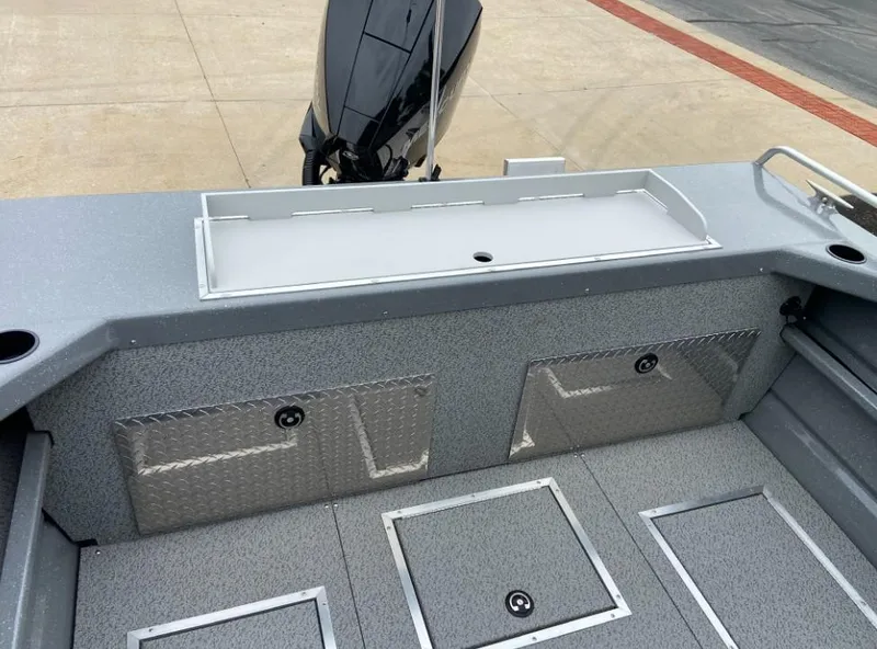 Slide: The Image of 2024 Spartan 200 Astoria boat interior with storage compartments and outboard motor. - 13