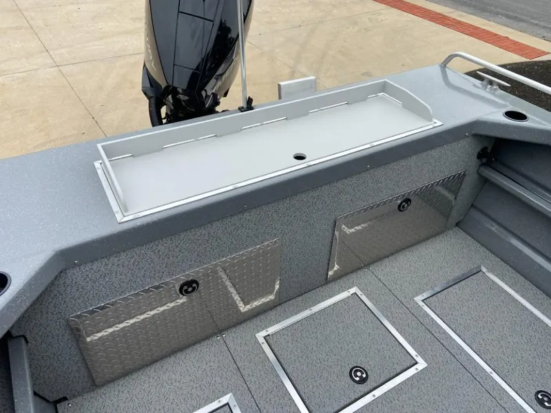 Slide: The Image of 2024 Spartan 200 Astoria boat interior with storage compartments and motor. - 14