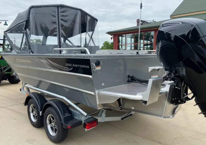 Slide: The Image of 2024 Spartan 200 Astoria boat on trailer with outboard motor. - 2