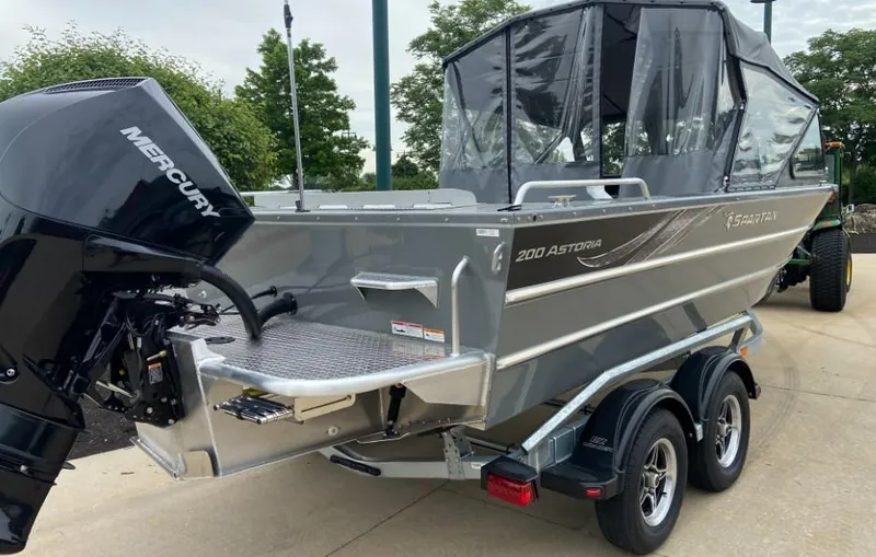 Slide: The Image of 2024 Spartan 200 Astoria boat with Mercury outboard motor on trailer. - 3