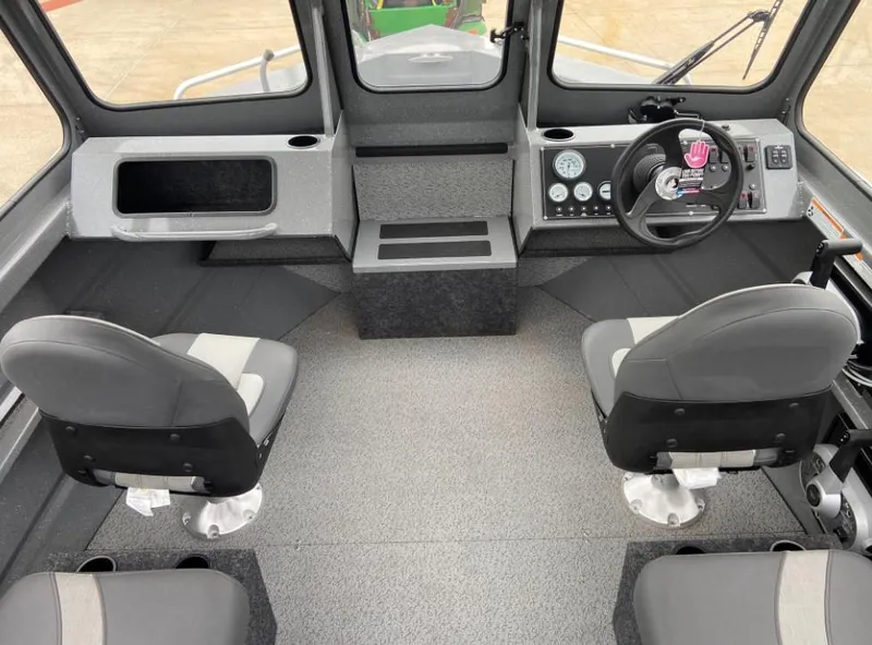 Slide: The Image of 2024 Spartan 200 Astoria boat interior with dual seats and control panel. - 4
