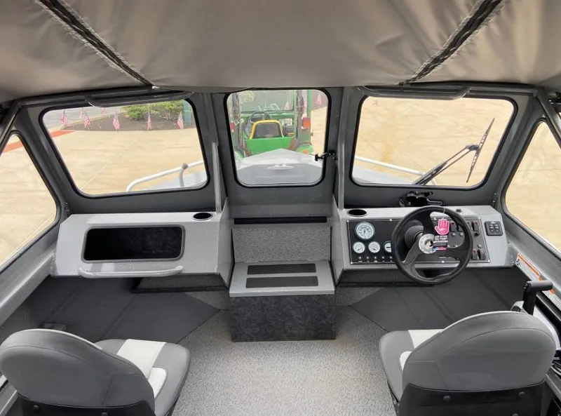Slide: The Image of 2024 Spartan 200 Astoria boat interior with dual seats and control panel. - 5