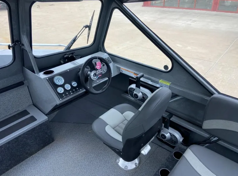 Slide: The Image of 2024 Spartan 200 Astoria boat cockpit with steering wheel and control panel. - 6