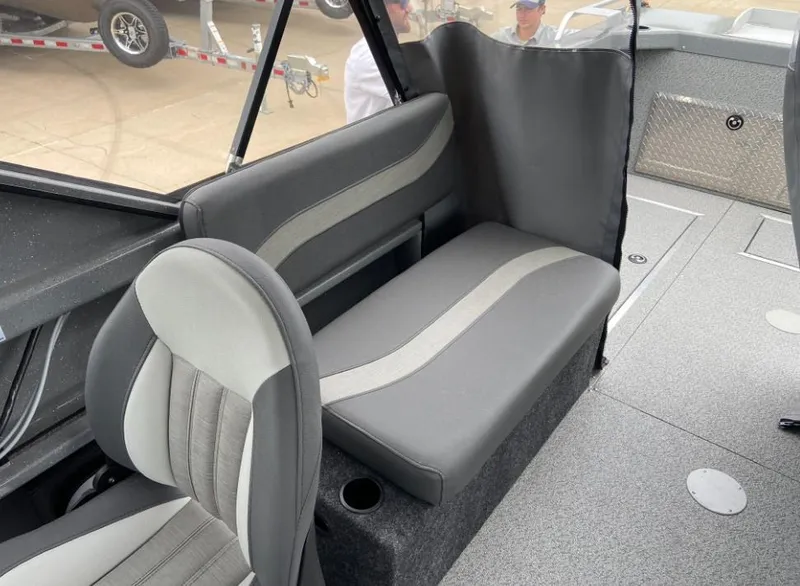 Slide: The Image of 2024 Spartan 200 Astoria boat interior with gray and white seating. - 9
