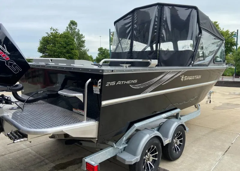 Slide: The Image of 2023 Spartan 215 Athens boat on trailer with black canopy. - 2