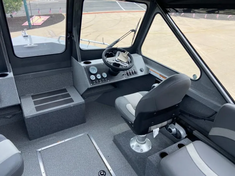 Slide: The Image of 2023 Spartan 215 Athens boat interior with steering wheel and seating. - 5