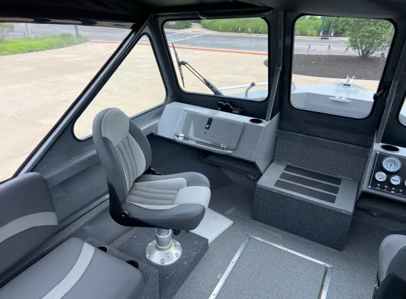 Slide: The Image of 2023 Spartan 215 Athens boat interior with seating and control panel. - 6