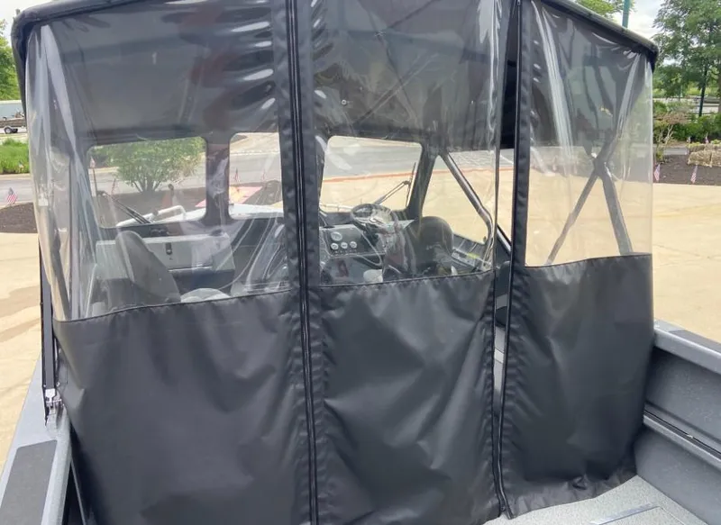 Slide: The Image of 2023 Spartan 215 Athens boat with enclosed cockpit and clear vinyl windows. - 7