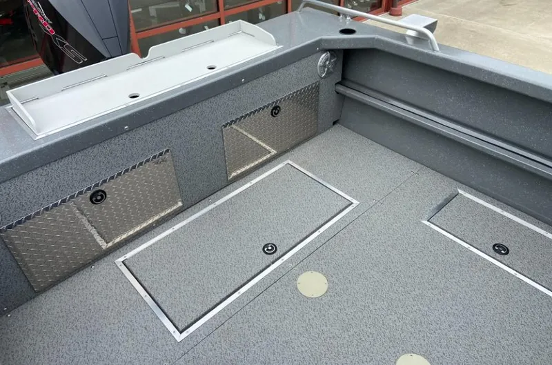 Slide: The Image of 2023 Spartan 215 Athens boat interior with storage compartments and non-slip flooring. - 8