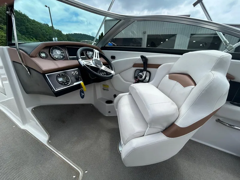Slide: The Image of 2017 Four Winns H210 boat interior with steering wheel and white-brown seating. - 5