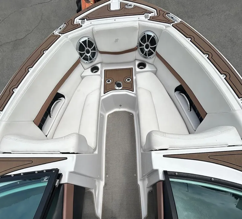 Slide: The Image of 2017 Four Winns H210 boat interior with white seating and brown accents. - 7