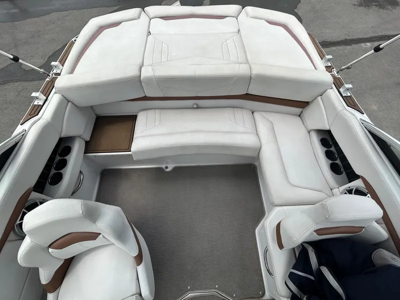 Slide: The Image of 2017 Four Winns H210 boat interior with white seating and cup holders. - 8