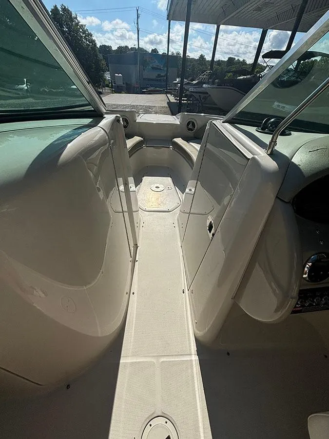 Slide: The Image of 2007 Sea Ray 220 Sundeck boat interior with open walkway and seating area. - 11