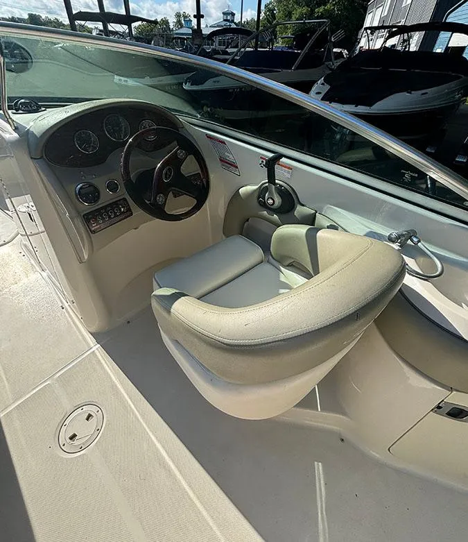 Slide: The Image of 2007 Sea Ray 220 Sundeck boat cockpit with steering wheel and control panel. - 8