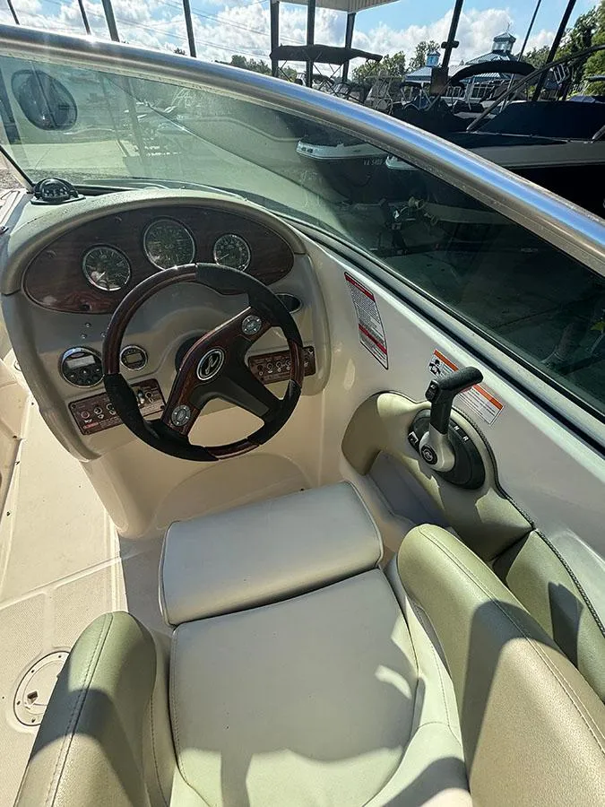 Slide: The Image of 2007 Sea Ray 220 Sundeck boat cockpit with steering wheel and control panel. - 9