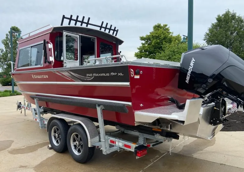 Slide: The Image of 2024 Spartan 240 MAXIMUS PRO XL boat on trailer with Mercury outboard motor. - 3