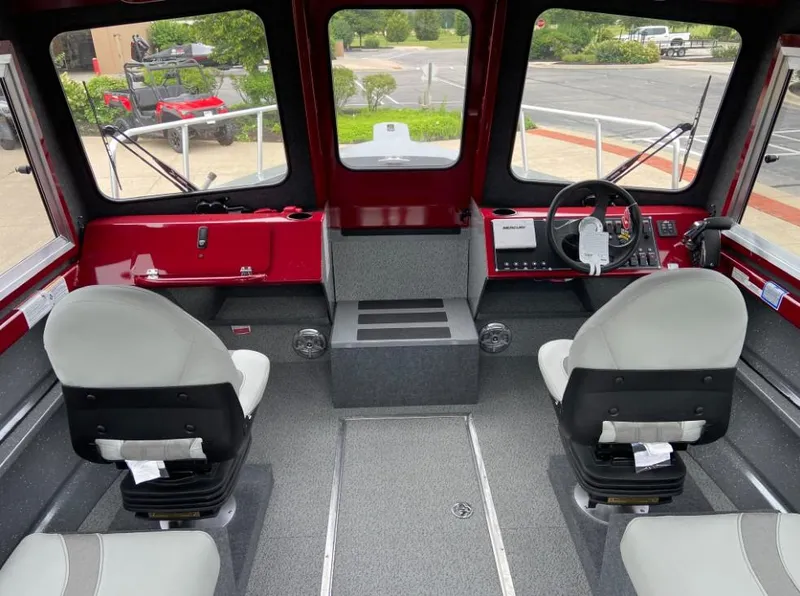 Slide: The Image of 2024 Spartan 240 MAXIMUS PRO XL boat interior with dual captain chairs and control panel. - 4