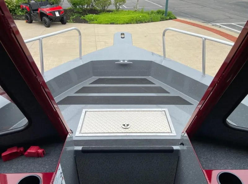 Slide: The Image of 2024 Spartan 240 MAXIMUS PRO XL boat deck with storage hatch and safety rails. - 5