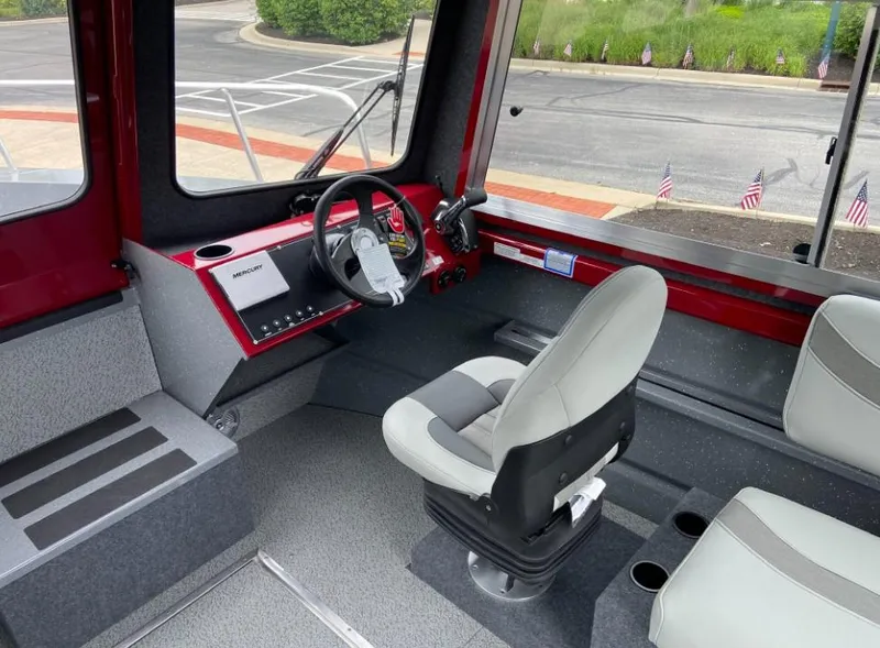 Slide: The Image of 2024 Spartan 240 MAXIMUS PRO XL boat interior with captain's chair and control panel. - 7