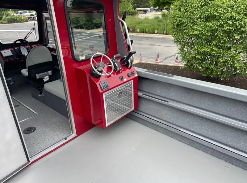 Slide: The Image of 2024 Spartan 240 MAXIMUS PRO XL boat interior with steering console and seating. - 9