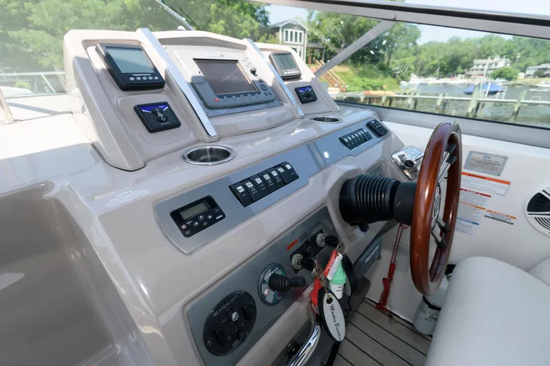 Slide: The Image of Chaparral Signature 350 2010 boat dashboard with steering wheel and control panels. - 10