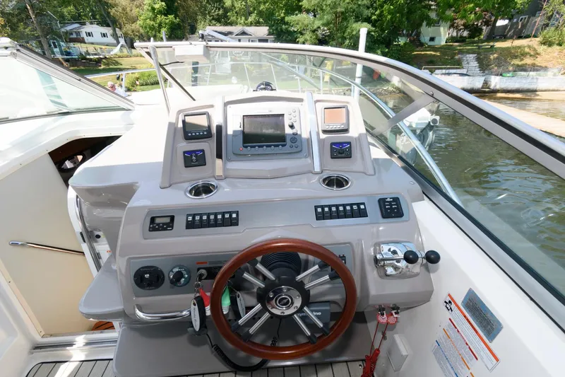 Slide: The Image of Helm of 2010 Chaparral Signature 350 boat with steering wheel and navigation controls. - 11