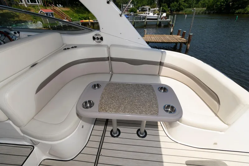 Slide: The Image of 2010 Chaparral Signature 350 boat interior with cushioned seating and table. - 13