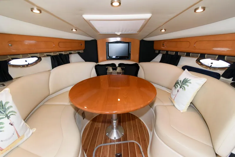 Slide: The Image of 2010 Chaparral Signature 350 interior with round table and leather seating. - 17