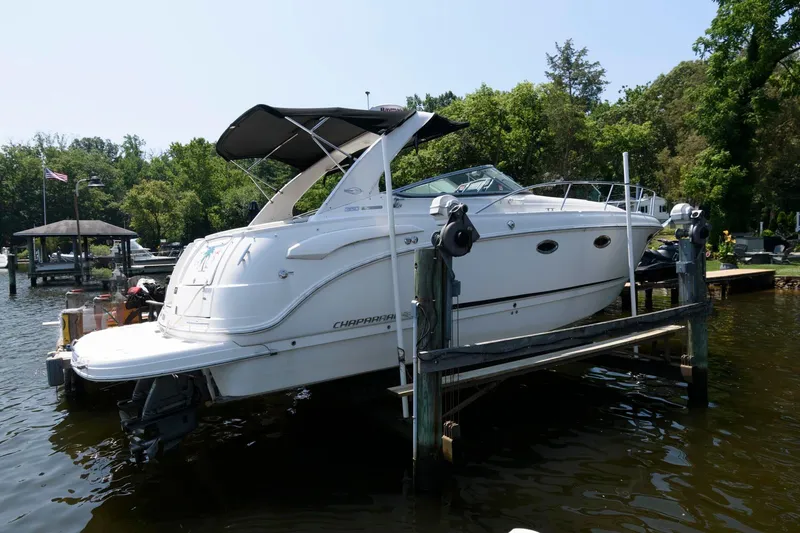 Slide: The Image of 2010 Chaparral Signature 350 boat docked on a lift in a scenic marina. - 2