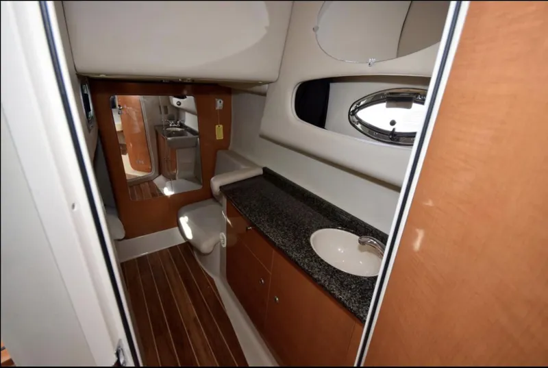 Slide: The Image of 2010 Chaparral Signature 350 bathroom with sink, toilet, and wooden cabinetry. - 20