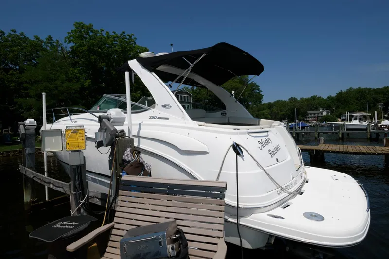 Slide: The Image of Chaparral Signature 350 2010 docked at a marina with lush greenery. - 5