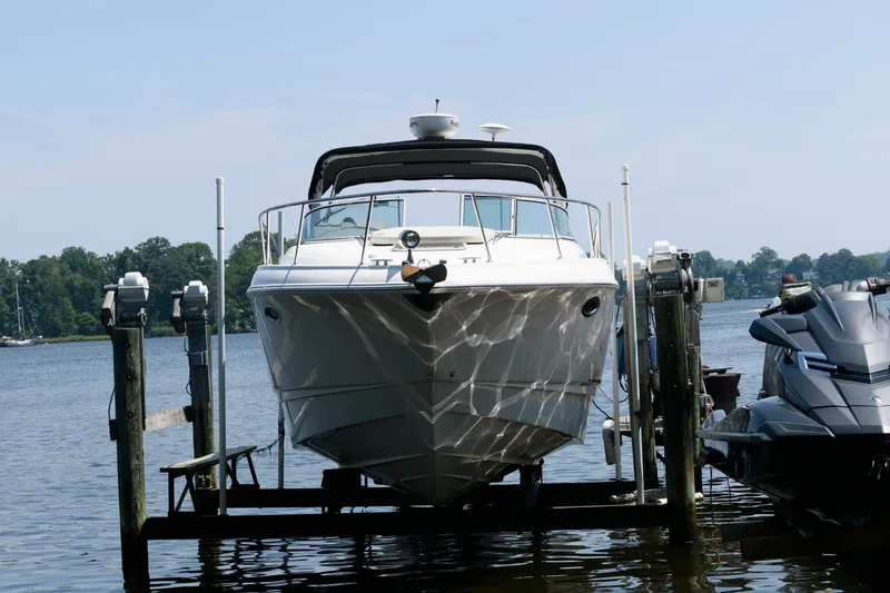 Slide: The Image of 2010 Chaparral Signature 350 boat docked on a lift by the water. - 6