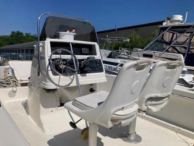 The Image of 1999 Wellcraft 190 CC F boat interior with steering console and seats. - 1