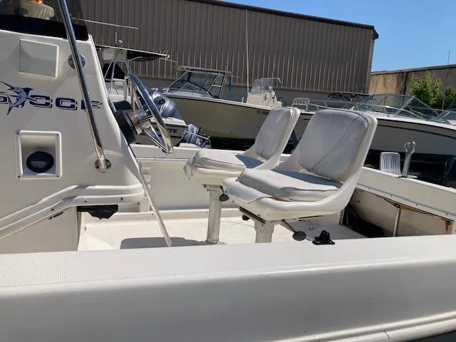 Slide: The Image of 1999 Wellcraft 190 CC F boat interior with dual white seats. - 3