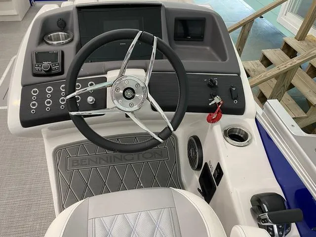 Slide: The Image of 2024 Bennington 25 QSB X1 pontoon boat interior with luxurious seating and modern design. - 18