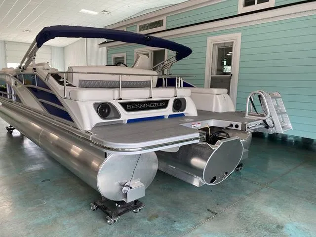 Slide: The Image of 2024 Bennington 25 QSB X1 pontoon boat in showroom, rear view. - 6