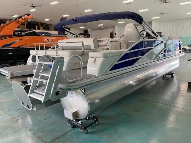 Slide: The Image of 2024 Bennington 25 QSB X1 pontoon boat interior with plush seating and modern helm. - 7