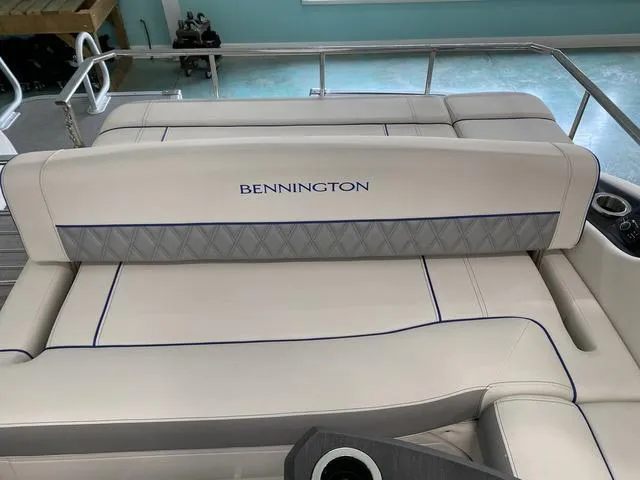 Slide: The Image of 2024 Bennington 25 QSB X1 boat interior with plush seating and table. - 9