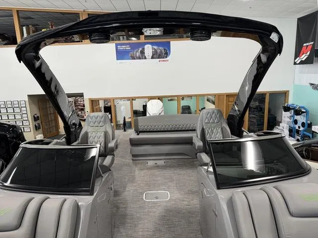Slide: The Image of 2024 Bennington 28 QXSBWA X1 boat interior with gray seating and carpet. - 12