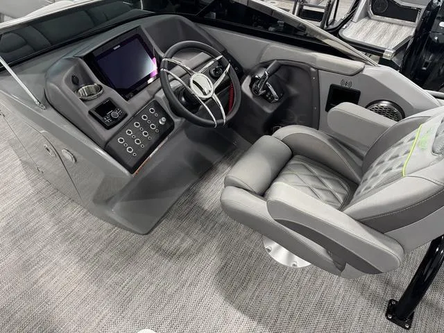 Slide: The Image of Interior of 2024 Bennington 28 QXSBWA X1 pontoon boat with grey seating and helm. - 15