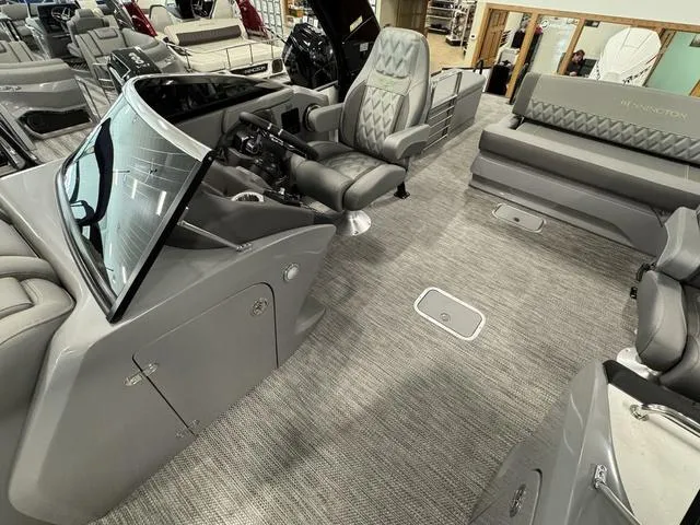 Slide: The Image of 2024 Bennington 28 QXSBWA X1 boat interior with luxurious seating and cup holders. - 22