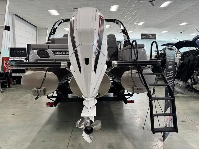 Slide: The Image of 2024 Bennington 28 QXSBWA X1 pontoon boat on display in indoor showroom. - 3