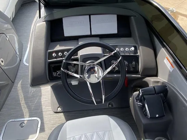 Slide: The Image of 2023 Bennington 27 RXFBWA T2 boat dashboard with steering wheel and controls. - 13