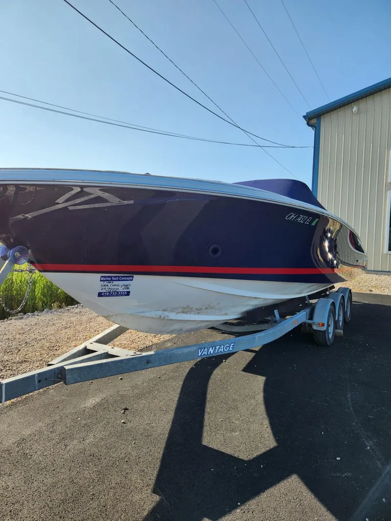 Slide: The Image of 2004 Chris-Craft Launch 28 boat on a trailer outside a storage building. - 1
