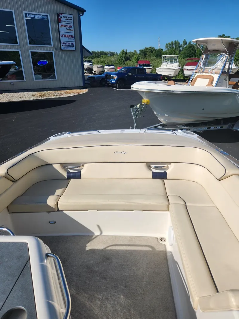 Slide: The Image of 2004 Chris-Craft Launch 28 boat with beige seating in a marina. - 10