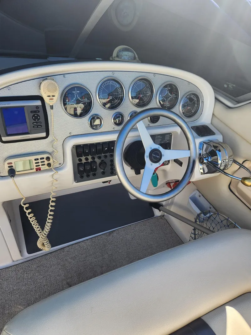 Slide: The Image of 2004 Chris-Craft Launch 28 boat dashboard with steering wheel and gauges. - 12