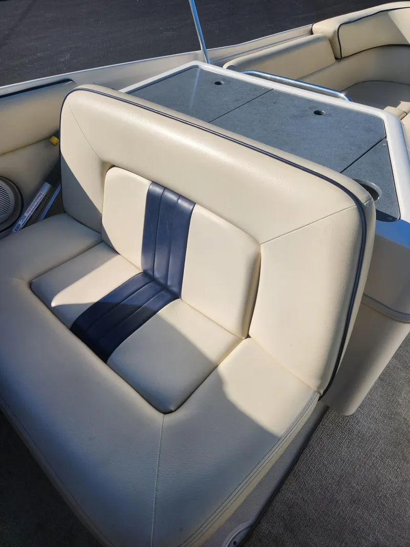 Slide: The Image of 2004 Chris-Craft Launch 28 boat with beige and blue cushioned seating. - 4