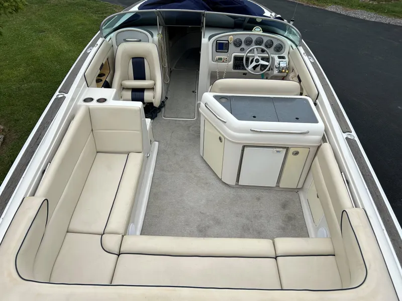 Slide: The Image of 2004 Chris-Craft Launch 28 boat interior with beige seating and modern dashboard. - 8