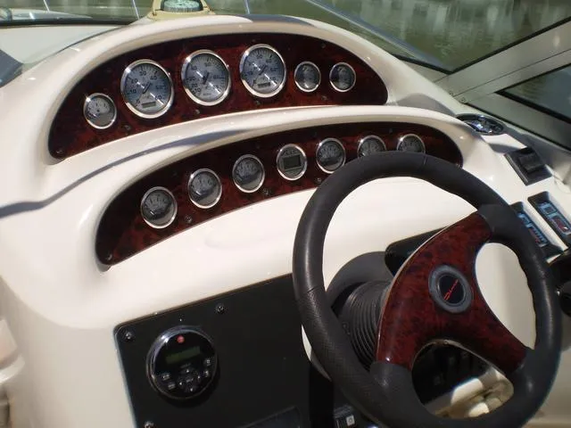 Slide: The Image of 2003 Monterey 302 boat dashboard with gauges and steering wheel. - 12